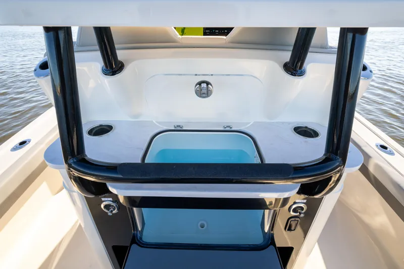 Slide: The Image of 2026 Scout 281 X Signature Edition boat interior with storage and cup holders. - 17
