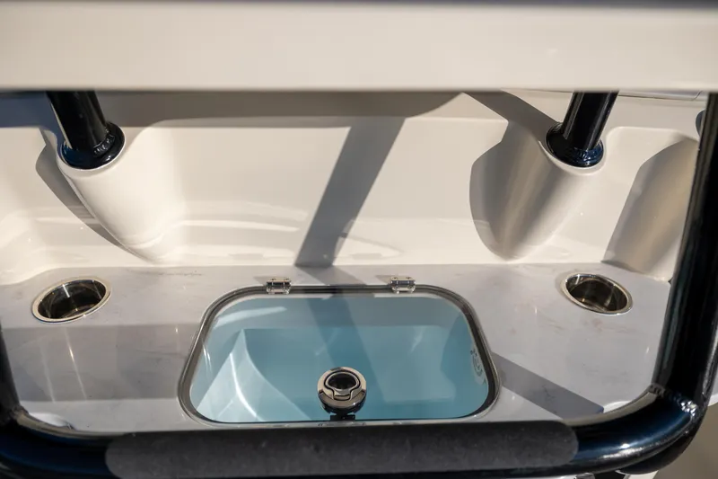 Slide: The Image of 2026 Scout 281 X Signature Edition boat interior detail with cup holders and storage compartment. - 18