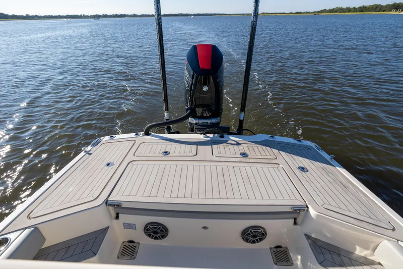 Slide: The Image of 2026 Scout 281 X Signature Edition boat on water, rear view with motor and deck. - 23