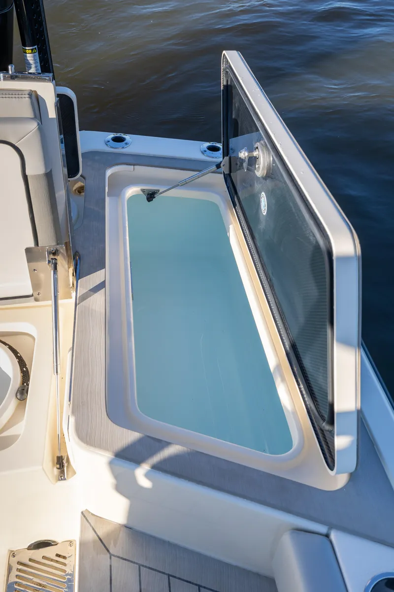 Slide: The Image of Open storage compartment on 2026 Scout 281 X Signature Edition boat. - 27