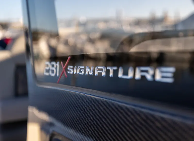 Slide: The Image of 2026 Scout 281 X Signature Edition boat logo close-up. - 31
