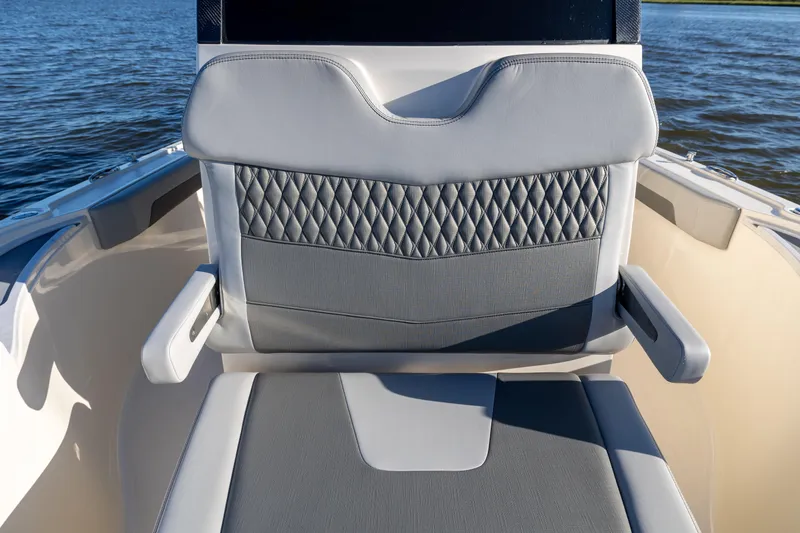 Slide: The Image of 2026 Scout 281 X Signature Edition boat seat with diamond-patterned upholstery on the water. - 9