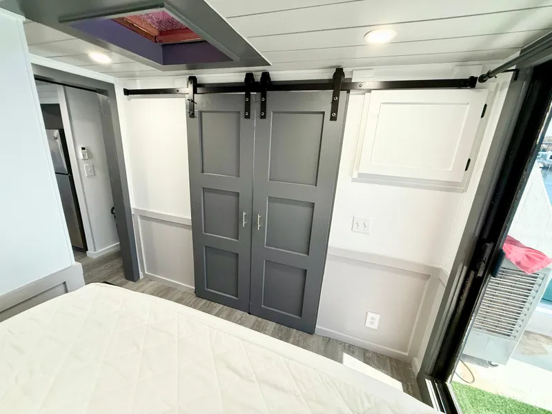 Slide: The Image of Interior of 1987 Three Buoys 5014 with sliding barn doors and modern decor. - 12