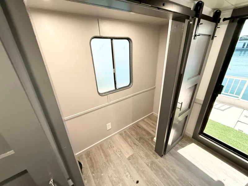 Slide: The Image of Interior of 1987 Three Buoys 5014 boat with window, sliding door, and wood flooring. - 13