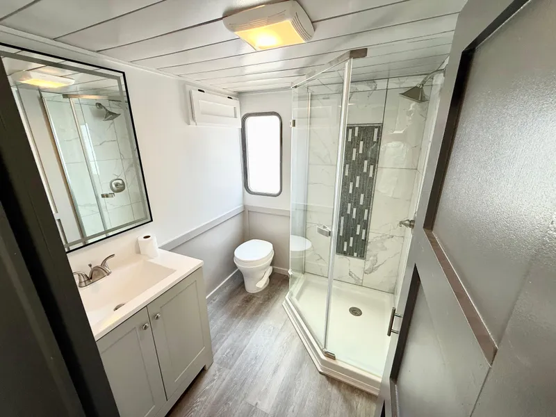 Slide: The Image of Modern bathroom in 1987 Three Buoys 5014 boat with shower, vanity, and toilet. - 15