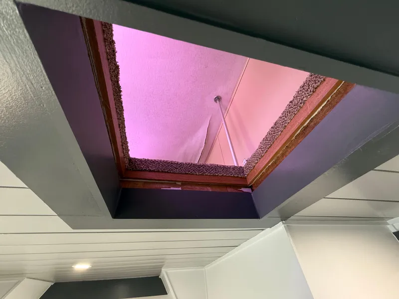 Slide: The Image of Ceiling hatch with pink lighting, viewed from below, in a 1987 Three Buoys 5014 model. - 22