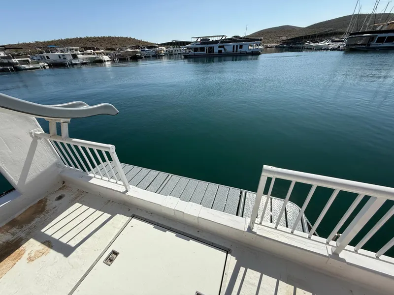 Slide: The Image of View from a 1987 Three Buoys 5014 houseboat overlooking a serene marina. - 25