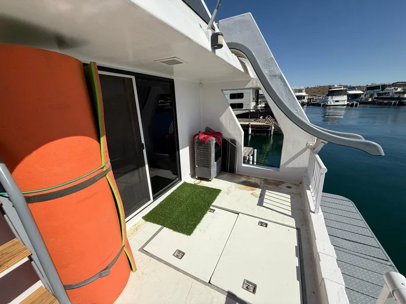 Slide: The Image of Houseboat deck with slide, orange float, and glass door, Three Buoys 5014, 1987 model. - 27