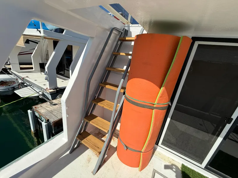 Slide: The Image of Staircase on 1987 Three Buoys 5014 boat with orange floatation device. - 28
