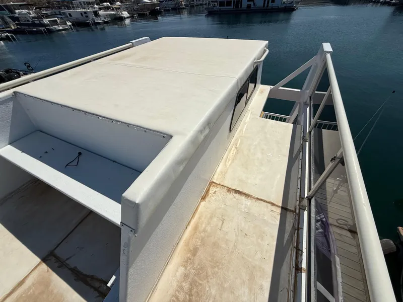 Slide: The Image of 1987 Three Buoys 5014 boat deck with railing, docked at marina. - 29