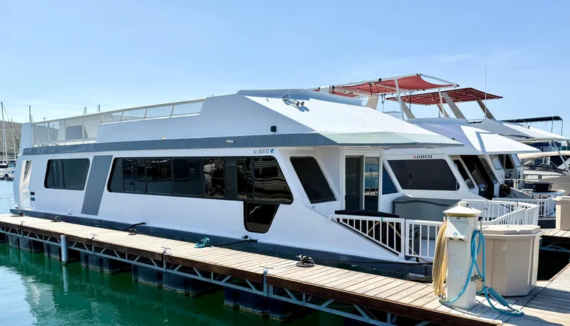 Slide: The Image of 1987 Three Buoys 5014 houseboat docked at marina under clear blue sky. - 3