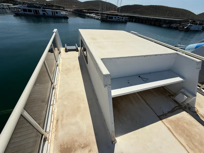 Slide: The Image of 1987 Three Buoys 5014 boat deck with railing, docked in a marina. - 30