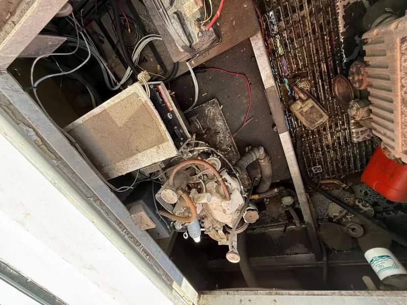 Slide: The Image of Engine compartment of a 1987 Three Buoys 5014, showing wiring and mechanical components. - 36