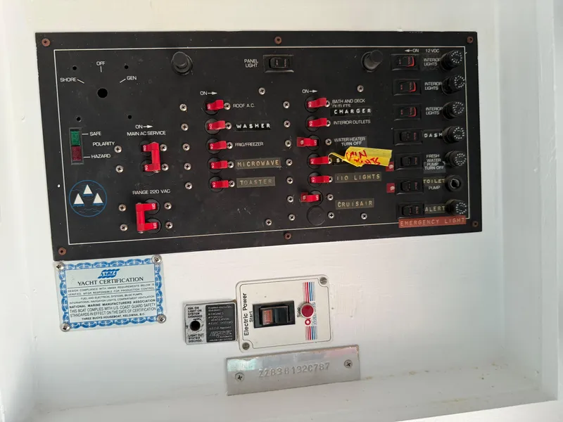 Slide: The Image of Control panel of a 1987 Three Buoys 5014 yacht with various switches and labels. - 37