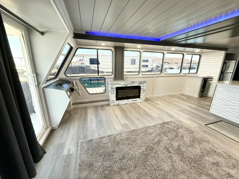 Slide: The Image of Modern interior of 1987 Three Buoys 5014 houseboat with fireplace and panoramic windows. - 6