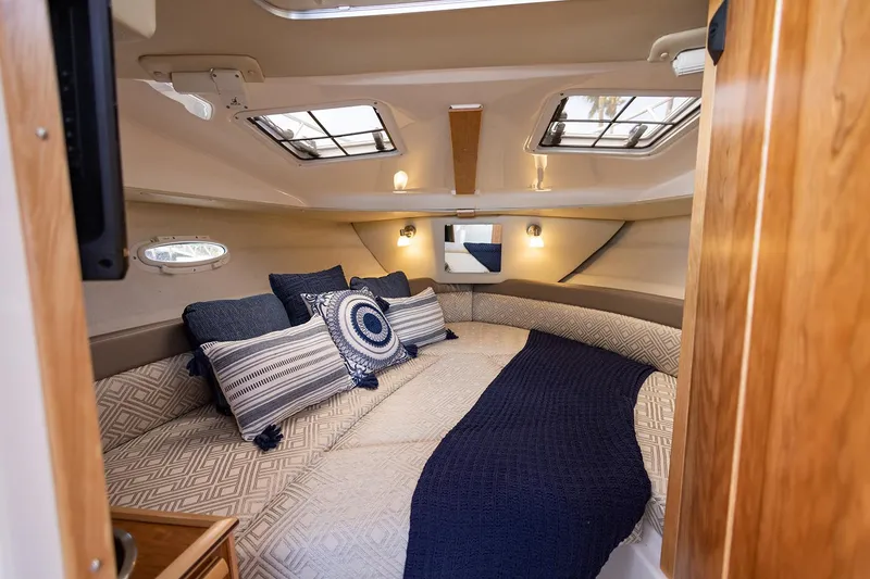 Slide: The Image of Manufacturer Provided Image: 2022 Cutwater C-248 Coupe interior cabin with cozy bedding and decorative pillows. - 13