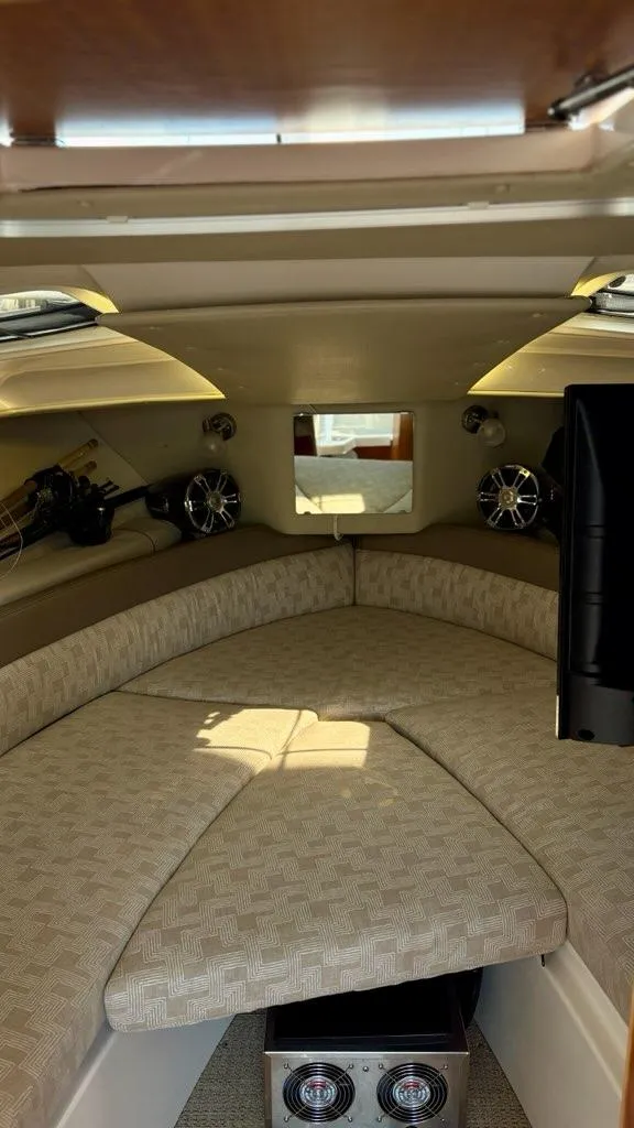 Slide: The Image of Interior of 2022 Cutwater C-248 Coupe, featuring a cozy cabin with cushioned seating. - 16