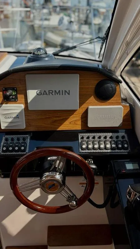 Slide: The Image of Helm of 2022 Cutwater C-248 Coupe with Garmin navigation system and wooden steering wheel. - 17