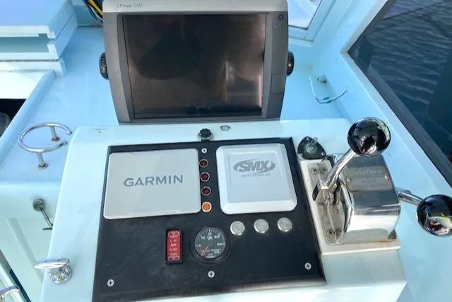 Slide: The Image of Control panel of a 1975 Custom Carolina Warren O'Neal boat with Garmin navigation. - 12