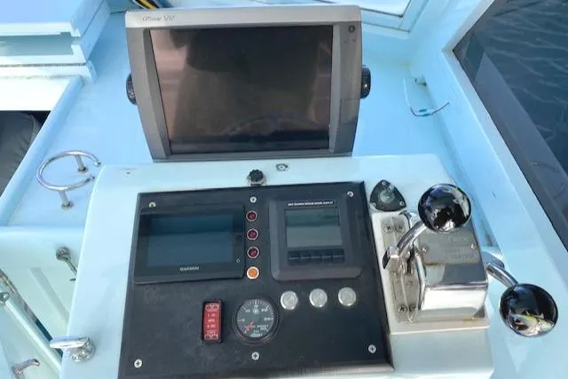 Slide: The Image of Control panel of a 1975 Custom Carolina Warren O'Neal boat with navigation equipment. - 13