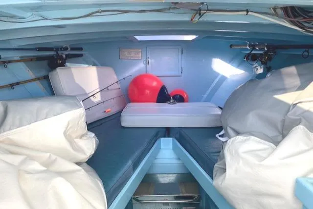 Slide: The Image of Interior of 1975 Custom Carolina Warren O'Neal boat with fishing gear and cushions. - 14