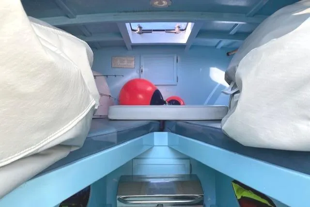 Slide: The Image of Interior of 1975 Custom Carolina Warren O'Neal boat with blue cabin and red buoy. - 15