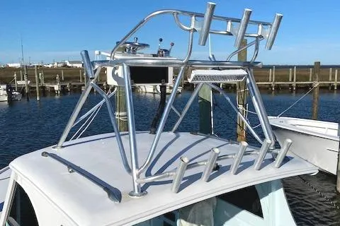 Slide: The Image of 1975 Custom Carolina Warren O'Neal boat with aluminum rod holders and tower at a marina. - 18