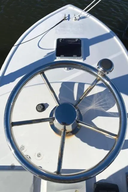 Slide: The Image of Steering wheel of a 1975 Custom Carolina Warren O'Neal boat, with a sleek metal design. - 20