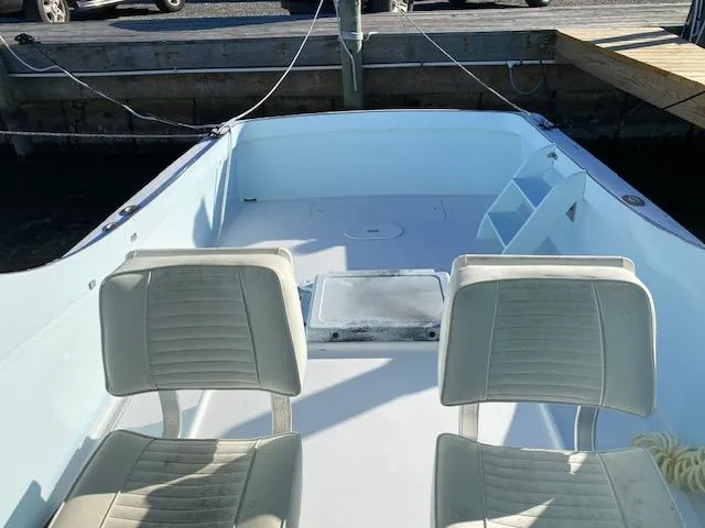 Slide: The Image of 1975 Custom Carolina Warren O'Neal boat interior with two white seats at a dock. - 9