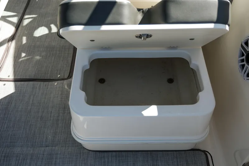 Slide: The Image of Open storage compartment on 2022 Robalo R247 DC boat. - 12