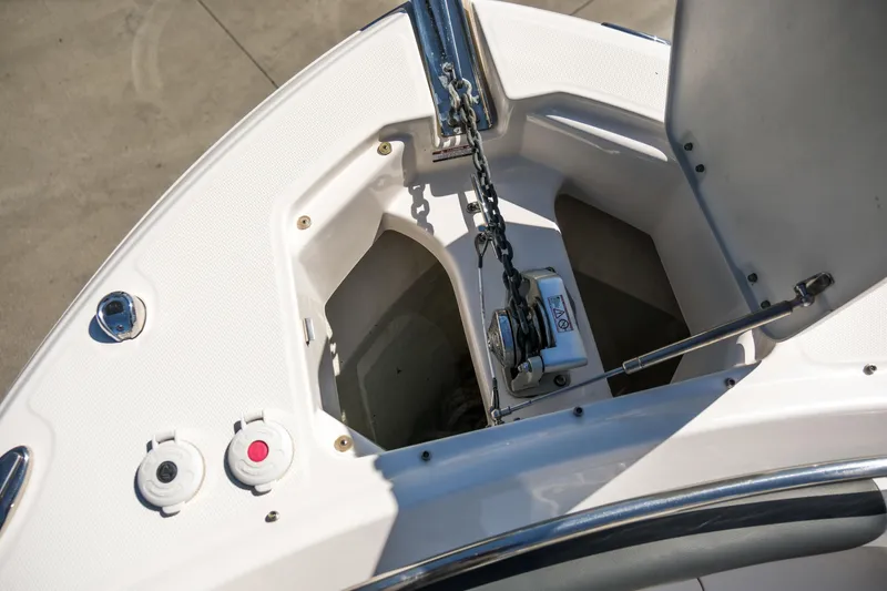 Slide: The Image of 2022 Robalo R247 DC boat anchor compartment with chain and winch system. - 6