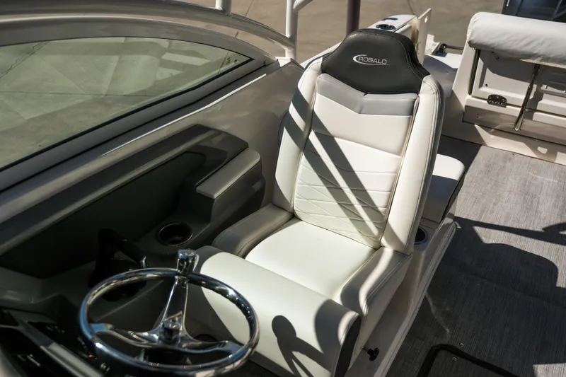Slide: The Image of 2022 Robalo R247 DC boat interior with white captain's seat and steering wheel. - 9