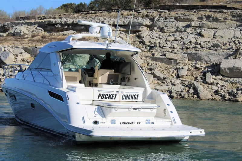 Slide: The Image of Sea Ray 450 Sundancer 2012 yacht named "Pocket Change" on water near rocky shore. - 14