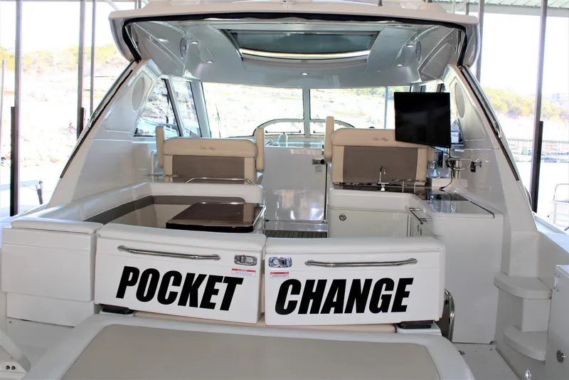 Slide: The Image of 2012 Sea Ray 450 Sundancer yacht interior with "Pocket Change" text on seating. - 16