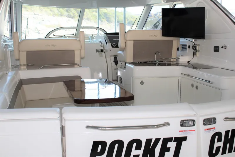 Slide: The Image of Interior of 2012 Sea Ray 450 Sundancer yacht with seating, table, and kitchenette. - 17