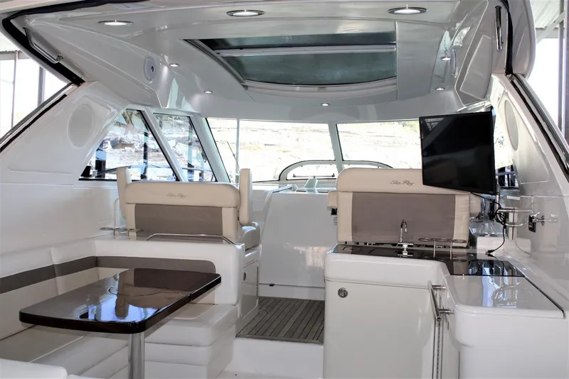 Slide: The Image of Interior of 2012 Sea Ray 450 Sundancer yacht with modern seating and entertainment area. - 19