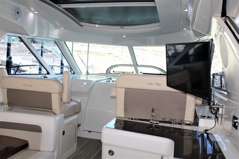 Slide: The Image of Interior of 2012 Sea Ray 450 Sundancer yacht with seating and mounted TV. - 24