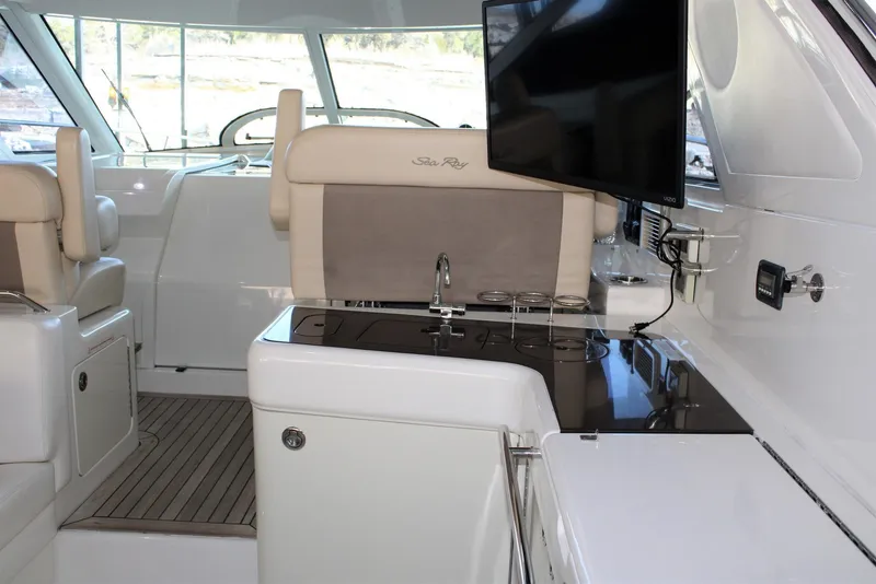 Slide: The Image of Interior of 2012 Sea Ray 450 Sundancer yacht with seating and entertainment area. - 25