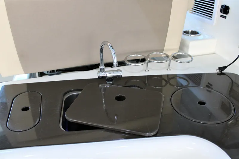 Slide: The Image of 2012 Sea Ray 450 Sundancer yacht kitchenette with sink and faucet. - 26