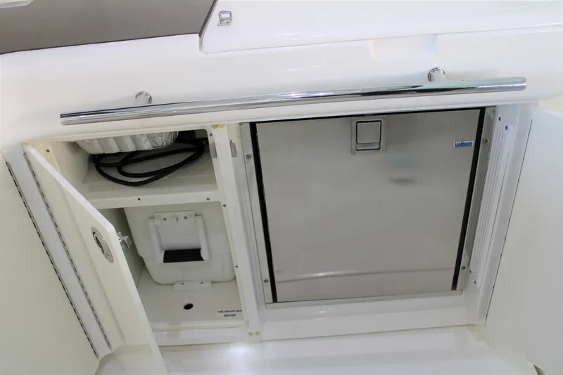 Slide: The Image of 2012 Sea Ray 450 Sundancer yacht interior with stainless steel fridge and storage compartment. - 28