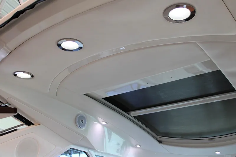 Slide: The Image of Interior ceiling of 2012 Sea Ray 450 Sundancer with recessed lighting and skylight. - 29