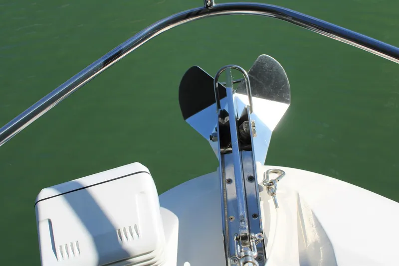 Slide: The Image of Bow view of 2012 Sea Ray 450 Sundancer with anchor and railing over green water. - 35