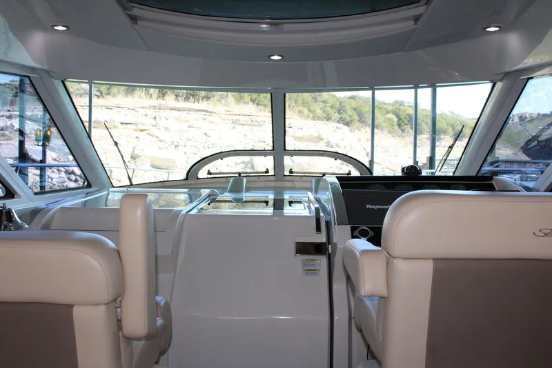 Slide: The Image of Interior view of 2012 Sea Ray 450 Sundancer yacht cockpit with modern controls and seating. - 37