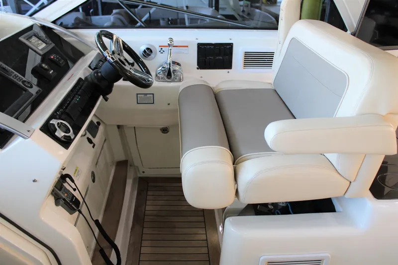 Slide: The Image of Helm of 2012 Sea Ray 450 Sundancer with leather seat and modern controls. - 42