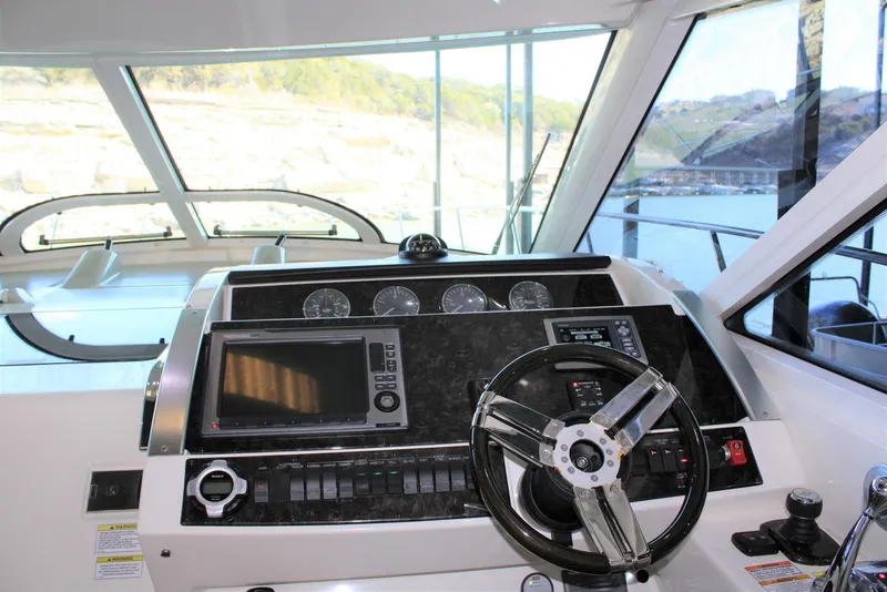 Slide: The Image of Helm of 2012 Sea Ray 450 Sundancer yacht with modern controls and navigation system. - 43