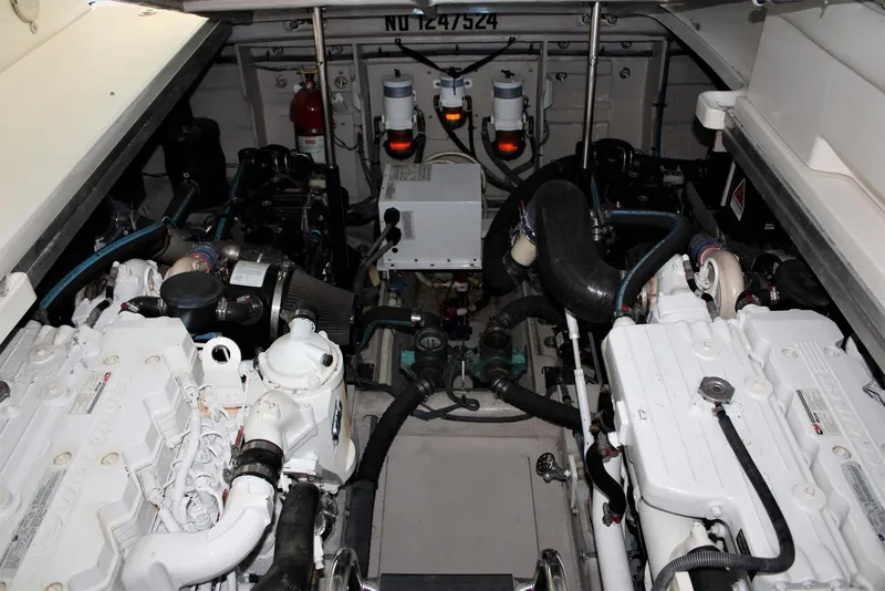 Slide: The Image of Engine room of 2012 Sea Ray 450 Sundancer, showcasing dual engines and mechanical components. - 47