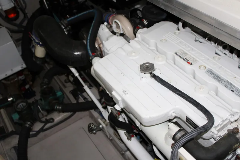 Slide: The Image of Engine compartment of 2012 Sea Ray 450 Sundancer boat, showcasing mechanical components. - 49