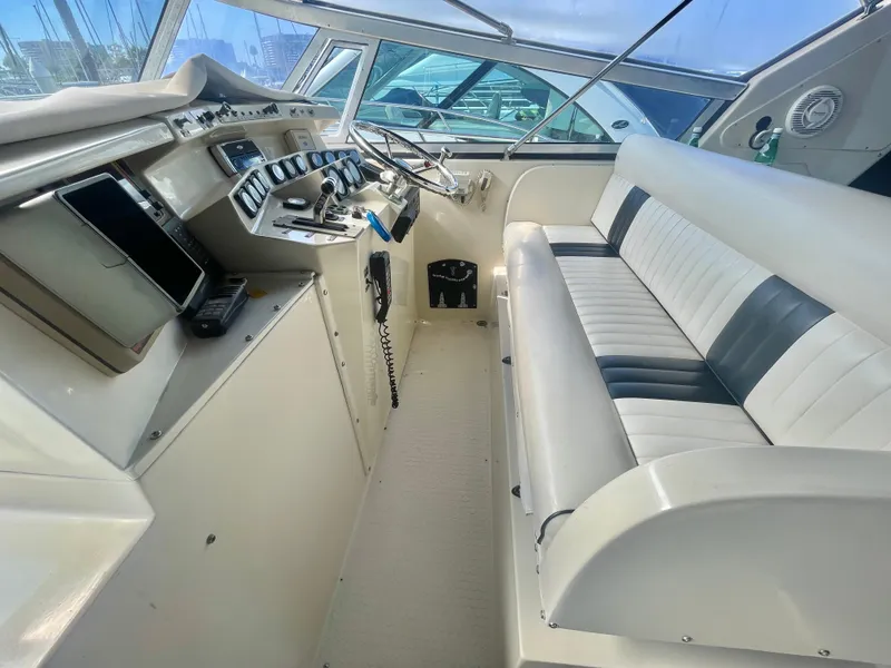 Slide: The Image of 1988 Californian express cruiser cockpit with steering controls and cushioned seating. - 12