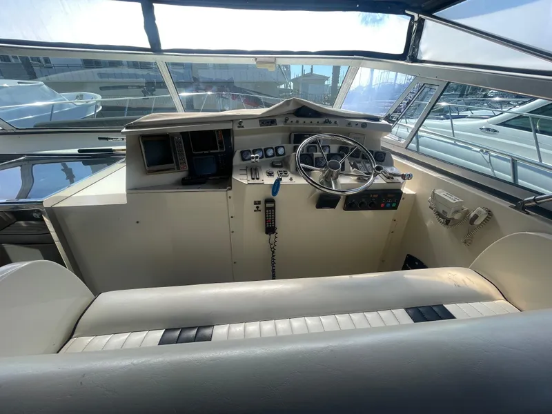 Slide: The Image of 1988 Californian express cruiser helm with steering wheel, controls, and navigation equipment. - 13