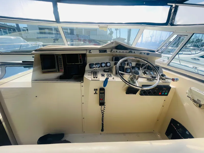 Slide: The Image of 1988 Californian express cruiser helm with steering wheel, controls, and navigation equipment. - 14